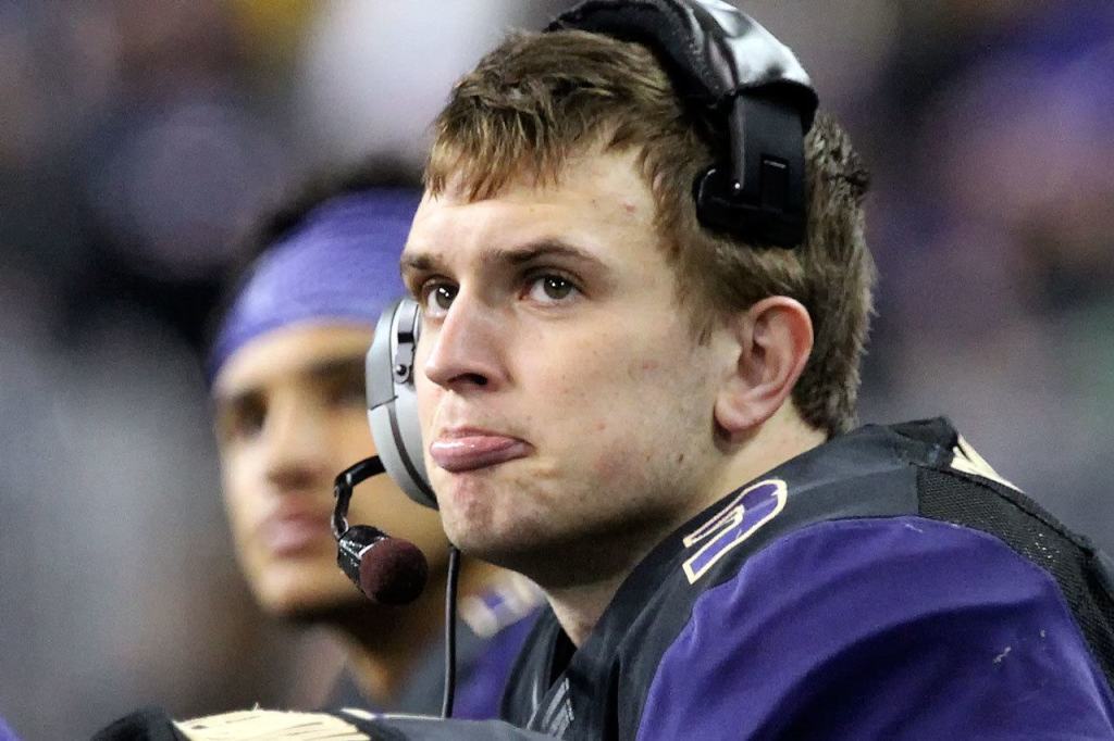 Washington quarterback Jake Browning reacts to the action on the field late in the fourth quarter Saturday night at Husky Stadium in Seattle. (Kevin Clark / The Herald)