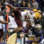 Arizona State&rsquo;s Kareem Orr is upended after an interception by Washington offensive lineman Coleman Shelton (bottom left) and Washington wide receiver Chico McClatcher on Saturday at Husky Stadium in Seattle. (Kevin Clark / The Herald)