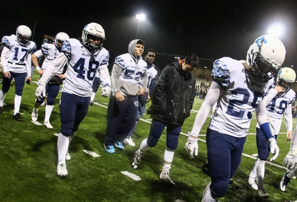 Meadowdale players walk off the field after losing to O&rsquo;Dea in a 3A state semifinal game Saturday at Pop Keeney Stadium in Bothell. O&rsquo;Dea won 35-9. (Kevin Clark / The Herald)