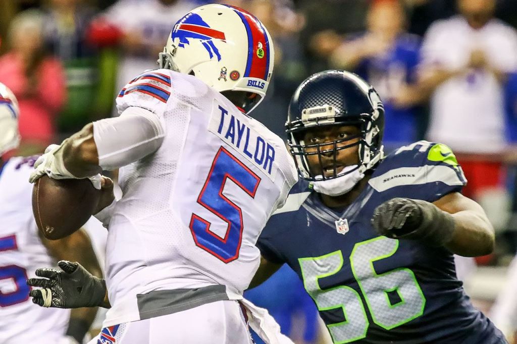 Bills quarterback Tyrod Taylor looks to pass with Seahawks defensive lineman Cliff Avril closing during Seattle&rsquo;s 31-25 win over Buffalo on Monday night. (Kevin Clark / The Herald)