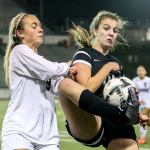 Jackson&rsquo;s Bryn Matheson defends Kamiak&rsquo;s Jamie Beirne&rsquo;s attempt to gather the ball during a district soccer match Thursday night Everett Memorial Stadium. (Kevin Clark / The Herald)