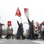 Industrial Workers of the World members walk along Hewitt Avenue in downtown Everett during a march Saturday afternoon to remember the victims of the 1916 Everett Massacre. (Ian Terry / The Herald)