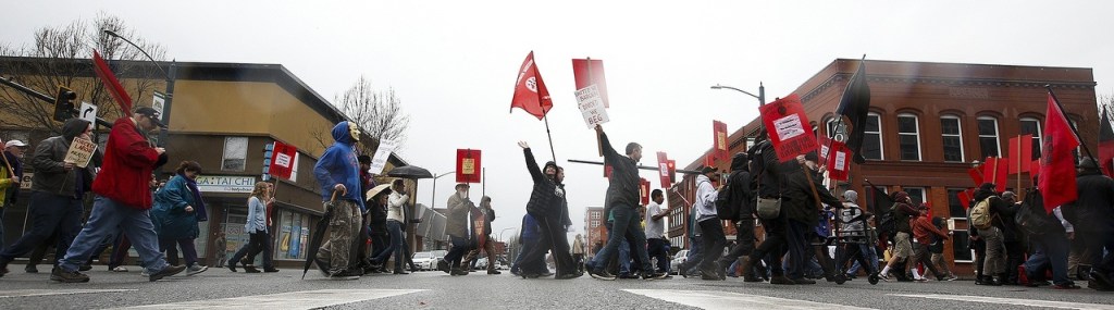 Industrial Workers of the World members walk along Hewitt Avenue in downtown Everett during a march Saturday afternoon to remember the victims of the 1916 Everett Massacre. (Ian Terry / The Herald)