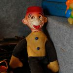 An unknown toy from the past peers from the shadows of a display in the Edmonds Historical Museum&rsquo;s &ldquo;Once Upon a Toy&rdquo; exhibit. (Dan Bates / The Herald)