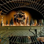 The dining room fireplace mantle, adorned in the season by Larry and Linda Jubie, is reflected in a large ornate mirror at the opposite side of the room. (Dan Bates / The Herald)