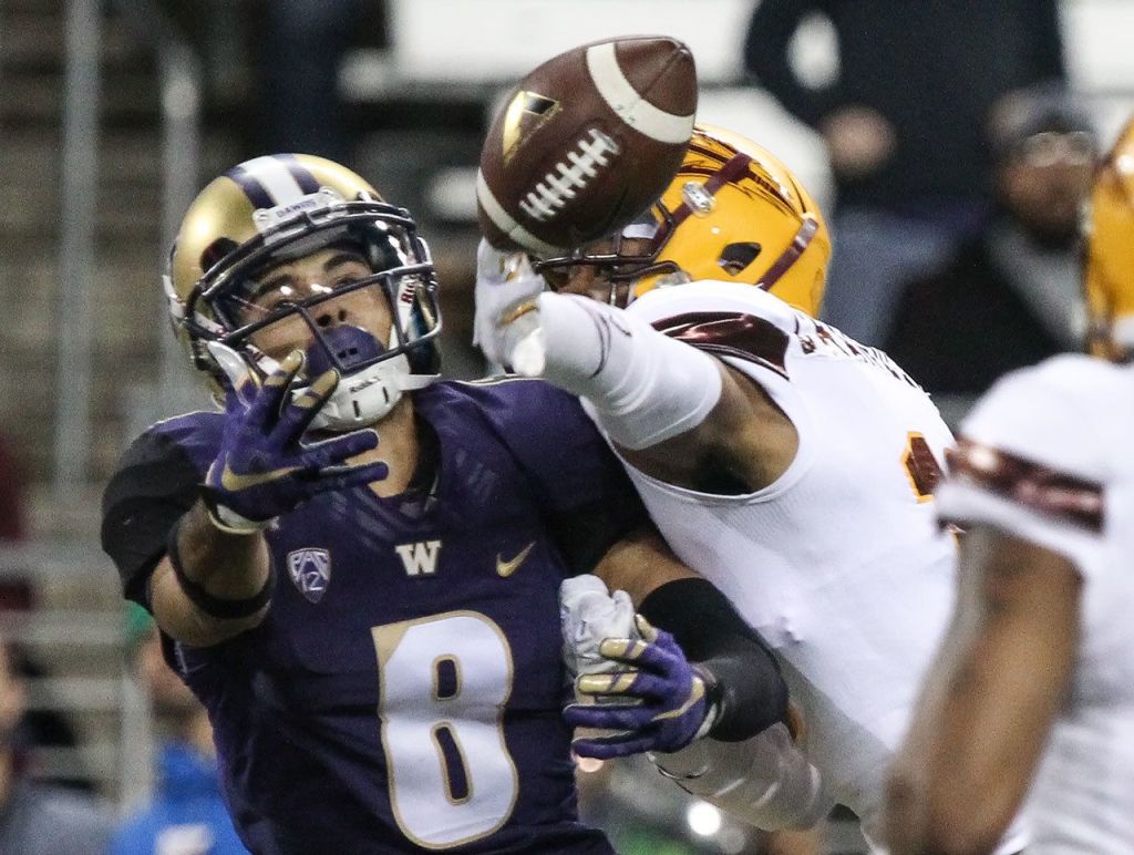 Washington wide receiver Dante Pettis reaches for the ball with Arizona State&rsquo;s Maurice Chandler breaking up the pass Saturday at Husky Stadium in Seattle. (Kevin Clark / The Herald)