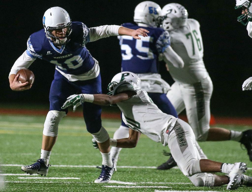 Meadowdale&rsquo;s Drew Tingstad is sacked by Peninsulas Braeden Potter during a 3A state quarterfinal game Friday at Edmonds Stadium. (Kevin Clark / The Herald)