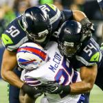 Seahawks linebackers K.J. Wright (left and Bobby Wagner tackle Bills running back LeSean McCoy during Seattle&rsquo;s 31-25 win over Buffalo on Monday night. (Kevin Clark / The Herald)