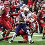 Washington wide receiver Chico McClatcher rushes toward the end zone with Washington State&rsquo;s Hunter Mattox attempting a tackle during the Apple Cup on Friday in Pullman. (Kevin Clark / The Herald)