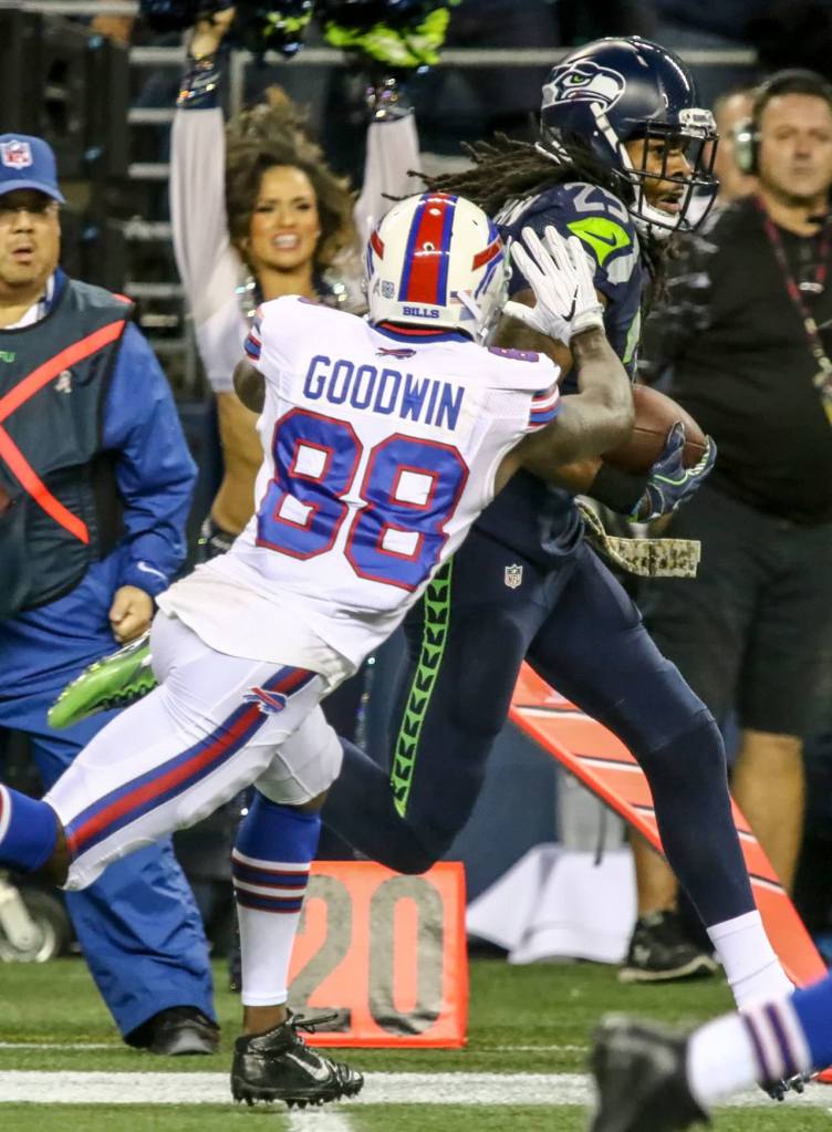 Seahawks cornerback Richard Sherman returns an interception with Bills wide receiver Marquise Goodwin closing during Seattle&rsquo;s 31-25 win over Buffalo on Monday night. (Kevin Clark / The Herald)