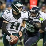 Eagles quarterback Carson Wentz is chased out of the pocket by Seahawks defensive lineman Cliff Avril Sunday afternoon at CenturyLink Field in Seattle on November 20, 2016. Seahawks won 26-15. (Kevin Clark / The Herald)