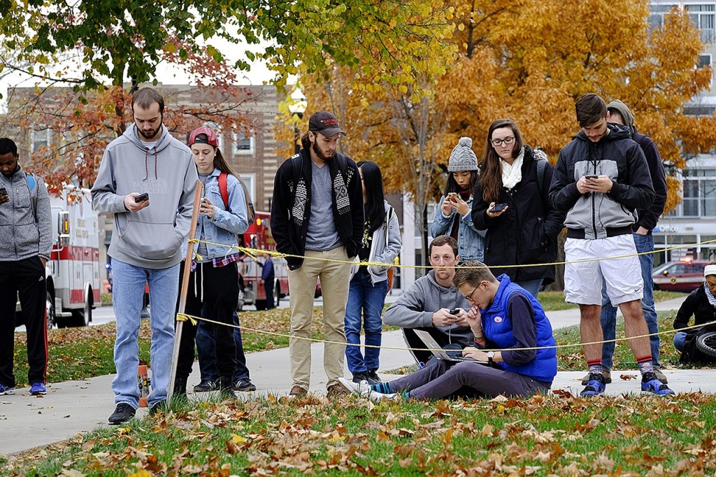 Students gather near the scene of an attack on the campus at Ohio State University on Monday, Nov. 28, in Columbus, Ohio. (Adam Cairns/The Columbus Dispatch via AP)
