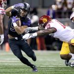 Washington running back Myles Gaskin works to avoid a tackle attempt by Southern California linebacker Michael Hutchings Saturday night at Husky Stadium in Seattle on November 12, 2016. (Kevin Clark / The Herald)