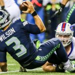 Seahawks quarterback Russell Wilson is sacked by Bills defensive lineman Kyle Williams during Seattle&rsquo;s 31-25 win over Buffalo on Monday night. (Kevin Clark / The Herald)