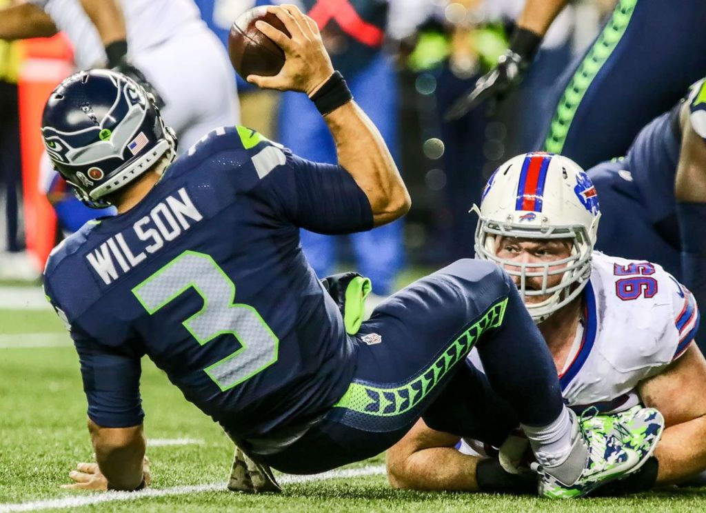 Seahawks quarterback Russell Wilson is sacked by Bills defensive lineman Kyle Williams during Seattle&rsquo;s 31-25 win over Buffalo on Monday night. (Kevin Clark / The Herald)