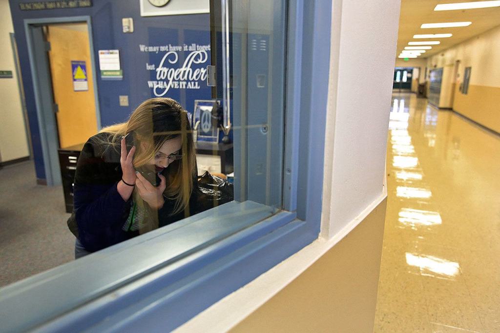 Jessiana King makes the morning announcements, as part of her leadership class, at Crossroads High School in Granite Falls. King is taking part in the GRADS program for teen parents as a full-time student. (Kevin Clark / The Herald)
