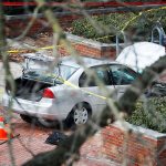 A car inside a police line sits on the sidewalk as authorities respond to an attack on campus at Ohio State University on Monday, Nov. 28, in Columbus, Ohio. (AP Photo/John Minchillo)