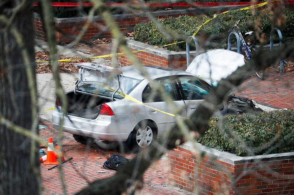 A car inside a police line sits on the sidewalk as authorities respond to an attack on campus at Ohio State University on Monday, Nov. 28, in Columbus, Ohio. (AP Photo/John Minchillo)