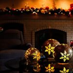 Lighted Christmas balls reflect on a glass table in the cozy family room at the Jubie house. (Dan Bates / The Herald)