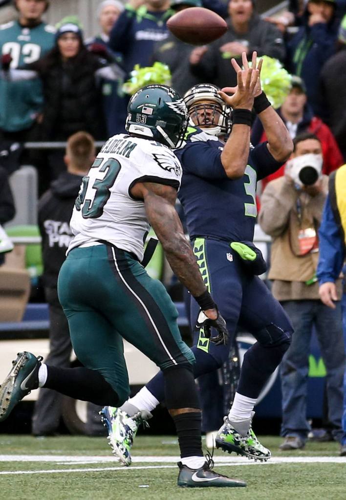 Seahawks quarterback Russell Wilson makes a reception from Seahawks wide receiver Doug Baldwin for a touchdown with Eagles linebacker Nigel Bradham trailing Sunday afternoon at CenturyLink Field in Seattle on November 20, 2016. Seahawks won 26-15. (Kevin Clark / The Herald)