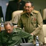Dec. 23, 2004: Fidel Castro is helped into his chair by his brother Raul Castro as he arrives to the National Assembly in Havana, Cuba. (AP Photo/Dario Lopez-Mills, File)
