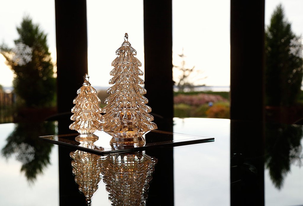 Framed by glass windows, glass trees stand reflecting on a glass table top in the Jubie home. (Dan Bates / The Herald)