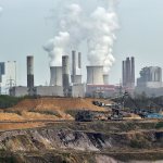 Giant machines dig for brown coal at the open-cast mining Garzweiler in front of a smoking power plant near the city of Grevenbroich, Germany, in 2014. (AP Photo / Martin Meissner)