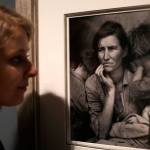 A Tate member of staff poses next to American photographer Dorothea Lange&rsquo;s &ldquo;Migrant Mother,&rdquo; from 1936, at the press view of &ldquo;The Radical Eye: Modernist Photography from the Sir Elton John Collection&rdquo; exhibition at the Tate Modern gallery in London on Tuesday. (AP Photo / Matt Dunham)