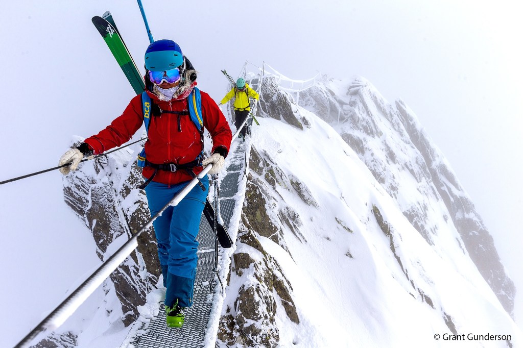 Photo courtesy Warren Miller Enterainment                                Grete Eliassen and Jess McMillan cross a footbridge at Andermatt in Switzerland.