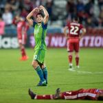 Seattle Sounders midfielder Nicolas Lodeiro (10) celebrates as FC Dallas midfielder Carlos Gruezo lies on the turf at the end of their MLS Western Conference semifinal playoff match Sunday in Frisco, Texas. (AP Photo/Jeffrey McWhorter)