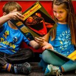 Want to see something REALLY SCARY? Leave it to kindergarten classmate Keelan Clark to find something scary in the book &ldquo;Is This a Monster?&rdquo; on Thursday and show it to Hayley Whitaker while reading newly acquired books in Lisa Brizendine&rsquo;s kindergarten class at Beverly Elementary School. Evelyn Holdt reads at left. The books are part of &ldquo;A reading library for kindergarteners,&rdquo; and include both fiction and nonfiction, Principal Danielle Sanders says. (Dan Bates / The Herald)