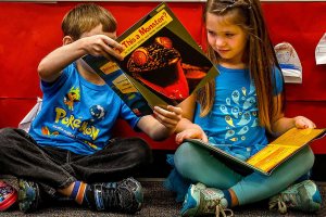 Want to see something REALLY SCARY? Leave it to kindergarten classmate Keelan Clark to find something scary in the book &ldquo;Is This a Monster?&rdquo; on Thursday and show it to Hayley Whitaker while reading newly acquired books in Lisa Brizendine&rsquo;s kindergarten class at Beverly Elementary School. Evelyn Holdt reads at left. The books are part of &ldquo;A reading library for kindergarteners,&rdquo; and include both fiction and nonfiction, Principal Danielle Sanders says. (Dan Bates / The Herald)