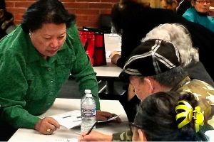 Van Dinh-Kuno (left), executive director of Refugee and Immigrant Services Northwest, answers questions about the general election ballot at an event sponsored by the Asian Pacific Islander Coalition on Friday at Everett Community College. Participants were U.S. citizens needing help from interpreters before casting their votes. (Julie Muhlstein / The Herald)