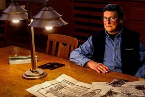 Frank Melder Jr, 77, shares what he knows about his grandfather Charles Curtiss, the National Guard lieutenant killed in the Everett Massacre, and what became of his grandmother after the Nov. 5, 1916, shootings. In the background is Camano Island artist Jack Gunter&rsquo;s painting &ldquo;The Everett Massacre,&rdquo; now on loan to the Everett Public Library. (Dan Bates / The Herald)