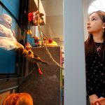 Darby Kelly, 7, niece of the Edmonds Historical Museum Director, Caitlin Kelly, explores display cases filled with very old play things that make up the current holiday exhibit &ldquo;Once Upon a Toy.&rdquo; (Dan Bates / The Herald)