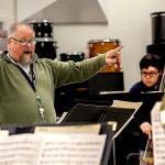 Edmonds Community College jazz band director John Sanders leads a rehearsal Monday of jazz and salsa band students at Edmonds Community College, which is trying to raise money to attend the Fiesta del Tambor in Havana this March. (Dan Bates / The Herald)