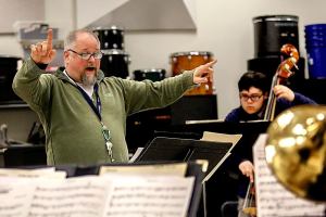 Edmonds Community College jazz band director John Sanders leads a rehearsal Monday of jazz and salsa band students at Edmonds Community College, which is trying to raise money to attend the Fiesta del Tambor in Havana this March. (Dan Bates / The Herald)