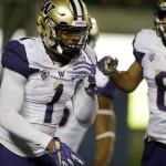 Washington&rsquo;s John Ross (1) celebrates with Dante Pettis (8) after scoring one of his three touchdowns against California on Saturday night. (AP Photo/Ben Margot)