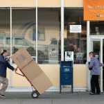 Customers go in and out of the U.S. Post Office at 3102 Hoyt Ave. on Thursday in Everett. The post office will not bemoving. (Andy Bronson / The Herald)