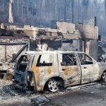 A scorched vehicle sits next to a burned out building in Gatlinburg, Tennessee, on Tuesday, Nov. 29. (AP Photo/Erik Schelzig)