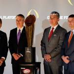 College football coaches from left to right; Nick Saban of Alabama, Chris Petersen of Washington, Ohio State&rsquo;s Urban Meyer and Dabo Sweeney of Clemson pose with the college football championship trophy Thursday in Atlanta. (AP Photo/John Bazemore)