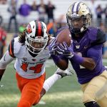 Washington&rsquo;s John Ross (right) makes a long pass reception in front of Oregon State&rsquo;s Treston Decoud during a game Oct. 22 in Seattle. Ross is the player of the year on the Associated Press All-Pac-12 team announced on Friday. (AP Photo/Elaine Thompson)