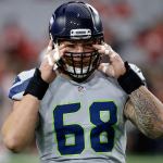 Seahawks center Justin Britt (68) puts on his helmet prior to a game against the Cardinals on Oct. 23 in Glendale, Ariz. (AP Photo/Ross D. Franklin)