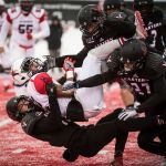 Richmond wide receiver Brian Brown (12) is tackled by Eastern Washington defensive back Mitch Fettig (bottom), defensive back Victor Gamboa (27) and linebacker Miquiyah Zamora (top) during a FCS playoff game Saturday in Cheney. (Colin Mulvany/The Spokesman-Review via AP)