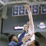 Gonzaga&rsquo;s Przemek Karnowski (center) shoots over Akron&rsquo;s Michael Hughes (left) during the second half of the Bulldogs&rsquo; 61-43 win over the Zips on Saturday in Spokane. (AP Photo/Young Kwak)