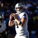 Raiders quarterback Derek Carr looks to throw a pass during a game against the Chargers on Dec. 18 in San Diego. (AP Photo/Denis Poroy)