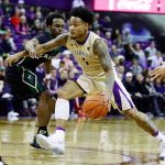 Washington guard David Crisp (1) drives past Cal Poly guard Donovan Fields during the first half of Tuesday night&rsquo;s game. Crisp led the Huskies with 21 points. (AP Photo/Ted S. Warren)