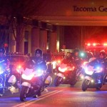 Motorcycle law enforcement officers lead a procession away from Tacoma General Hospital of an ambulance bearing the body ofTacoma police officer Reginald &ldquo;Jake&rdquo; Gutierrez, who was shot and killed while answering a domestic violence call Wednesday in Tacoma. Tacoma police spokeswoman Loretta Cool said Gutierrez was pronounced dead at the hospital Wednesday evening. &ldquo;We&rsquo;ve suffered a great loss and I think the community has suffered a great loss. I don&rsquo;t know how to put that into words,&rdquo; Cool said. (AP Photo/Ted S. Warren)