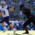 Washington quarterback Jake Browning (3) points to Oregon&rsquo;s Jimmie Swain (18) while rushing for a touchdown in the first quarter of a game Oct. 8 in Eugene, Ore. (Joshua Bessex/The News Tribune via AP)