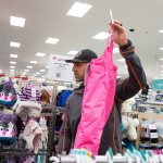 Lake Stevens Fire firefighter Brian Kees looks to his wife Leslie to ask if these ski pants fit a 5-year-old girl as he and a dozen firefighters buy toys and clothes at Target on Thursday, Dec. 15, 2016 in Lake Stevens, Wa. The Christmas gifts were for 70 children at the Lake Stevens Family Center.(Andy Bronson / The Herald)